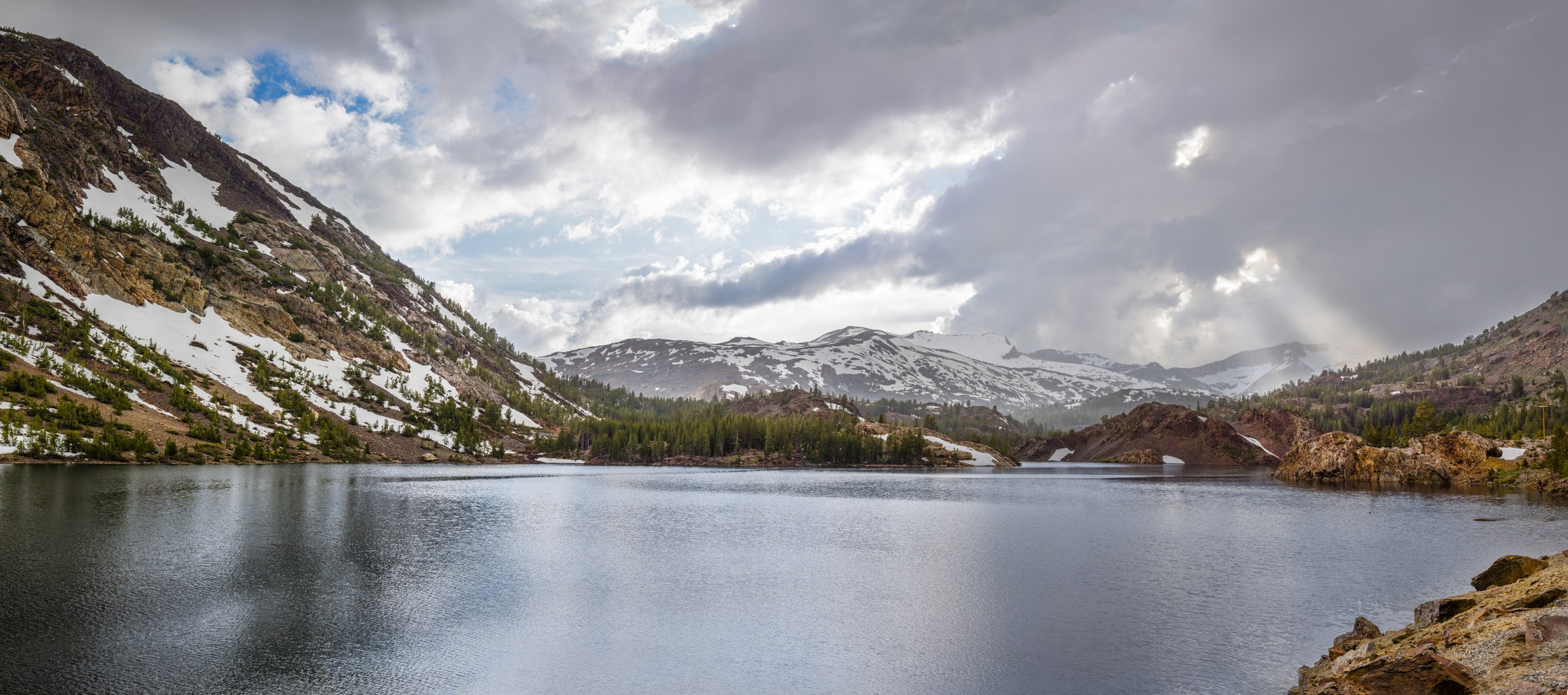 God rays shining through storm clouds at Ellery Lake (Panorama)