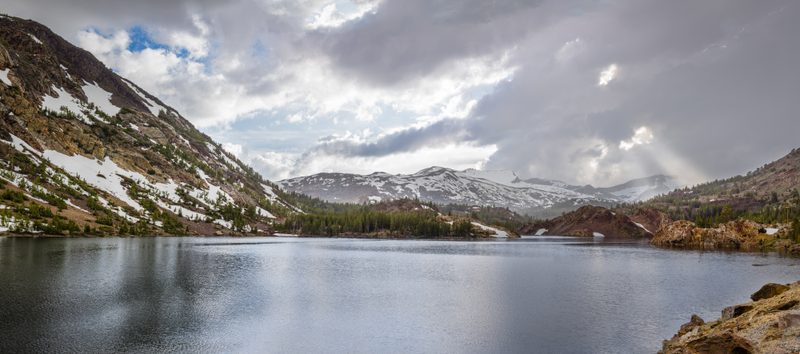 God rays shining through storm clouds at Ellery Lake (Panorama)